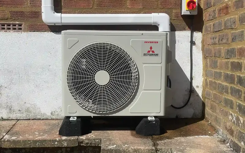 Outdoor condenser unit fitted to a wall, Hove installation
