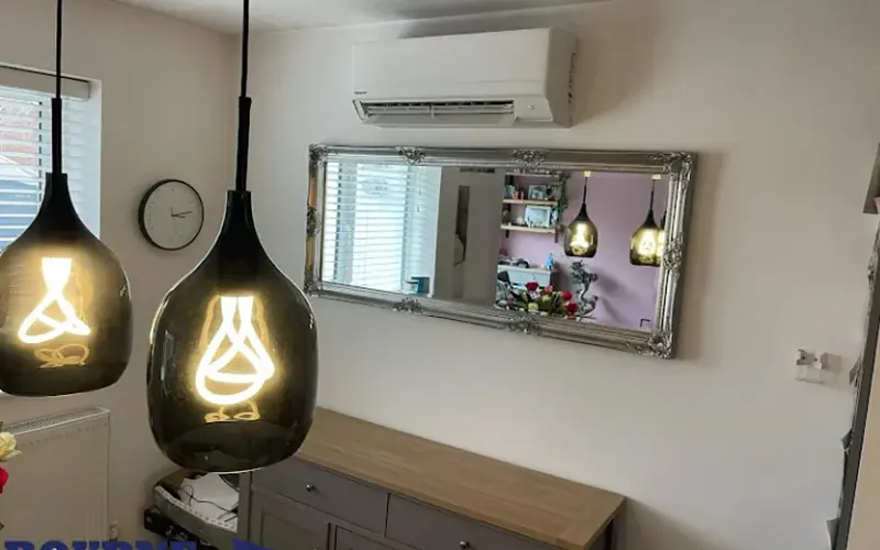 Wall-mounted indoor unit above a mirror, home installation