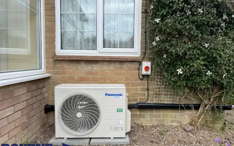 Panasonic outdoor unit beside a window