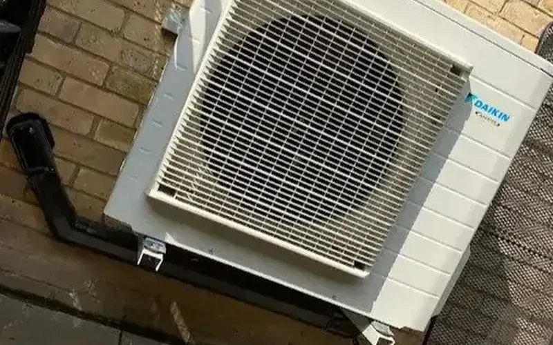 Daikin outdoor unit fixed to a brick wall