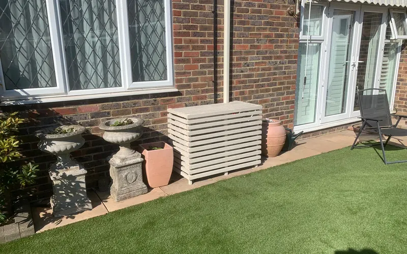 Outdoor unit behind a bespoke slatted cover, Angmering