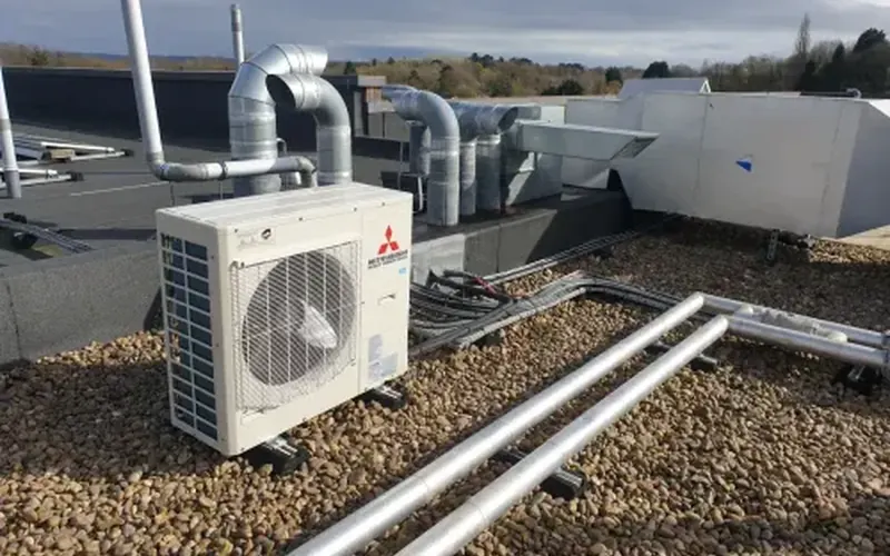Mitsubishi outdoor air conditioning unit on a flat roof