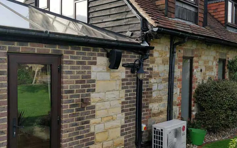 Outdoor unit beside a cottage extension (project gallery)