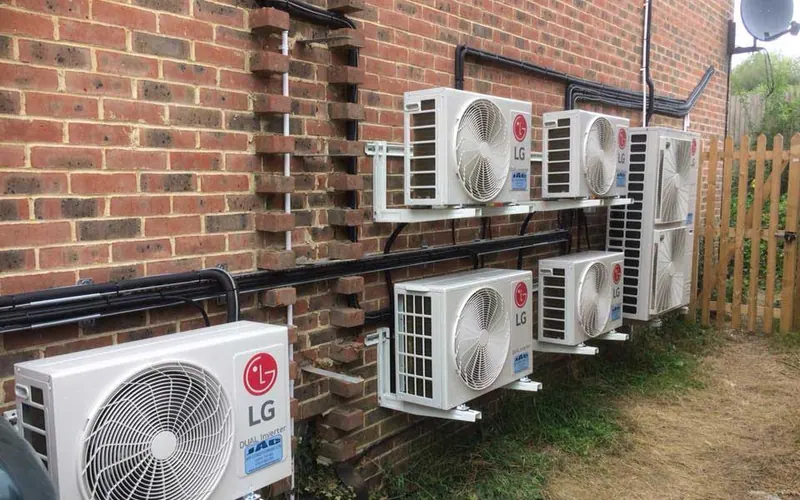 Bank of outdoor units on a brick wall (project gallery)