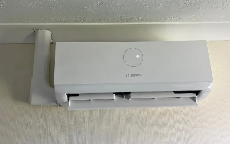 Bosch wall-mounted indoor unit fitted near the ceiling with a neat trunking run
