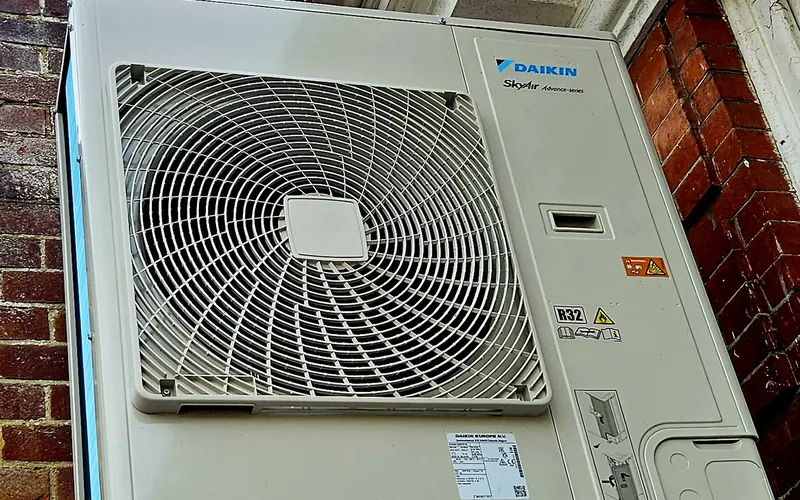 Daikin outdoor unit mounted on a brick wall